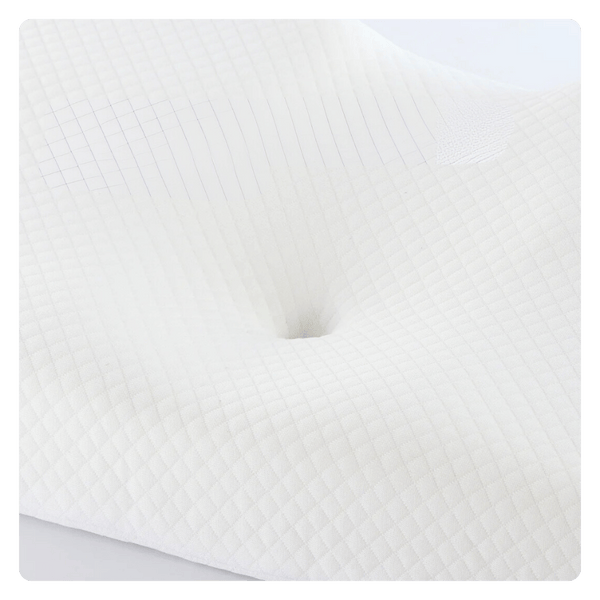 The picture is a closeup of the head cradle in the center of the pillow. The picture highlights the ergonomic contour design and how the pillow supports the natural curvature of the spine to improve alignment. 